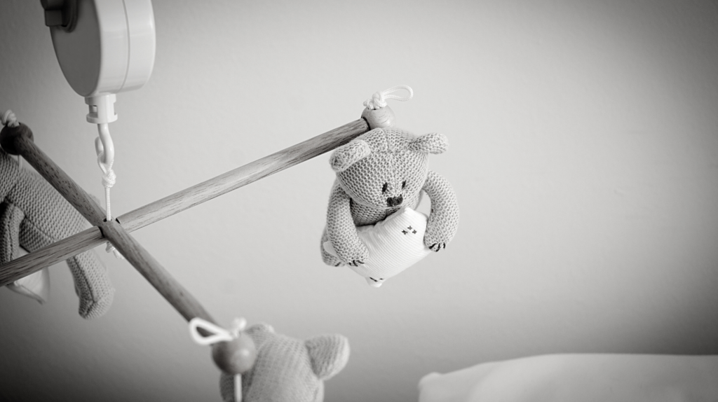 Bear mobile hanging above empty crib