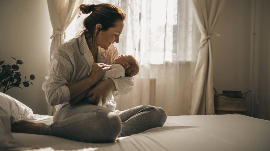 woman on bed holding baby first three days